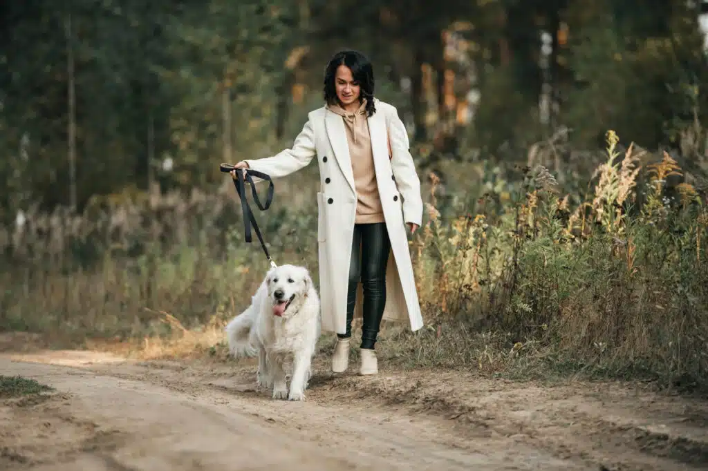 woman-walking-her-dog-in-the-nature