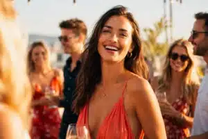 most magnetic zodiac sign shown by one glowing person drawing every glance at a sunlit summer gathering