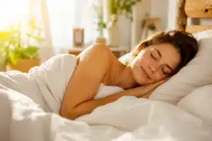 Person curled up asleep under soft light, what your sleep position says about who you are